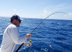 Man reeling in a fish