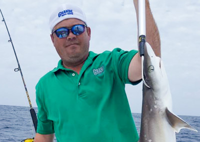 Man holding shark.