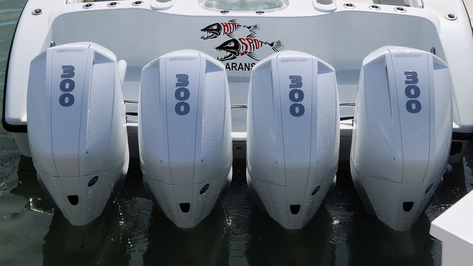 four boat motors on back of boat